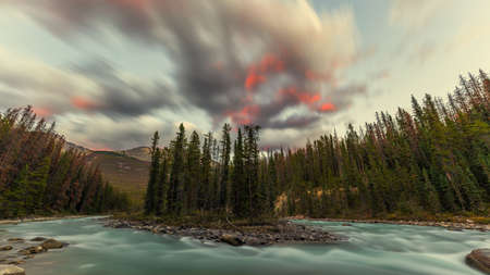 Beautiful red tipped clouds over Sunwapta River close to Sunwapta Falls in Jasper National Park, Alberta, Canada.の写真素材