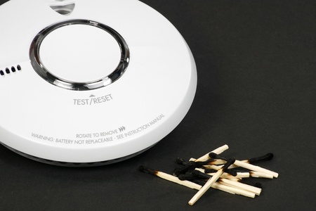 smoke alarm and burned matches fire danger conceptの写真素材