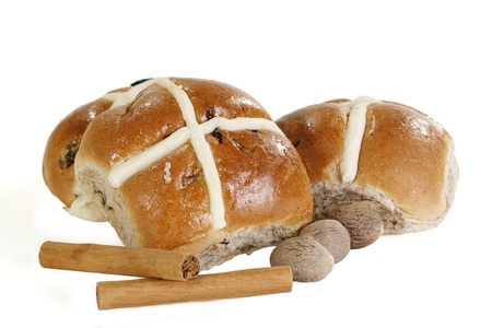 two spiced hot cross buns with cinnamon and nutmeg isolated on whiteの写真素材