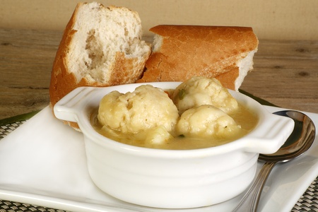 bowl of hot vegetable stew with vegetable suet dumplingsの写真素材