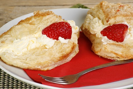 flakey pastry cakes filled with whipped cream apple and strawberriesの写真素材
