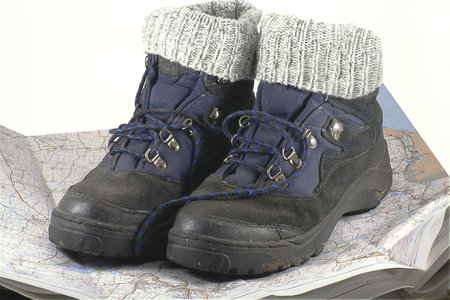 pair of hiking boots resting on a map