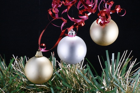 three christmas tree decorations isolated on a black backgroundの写真素材