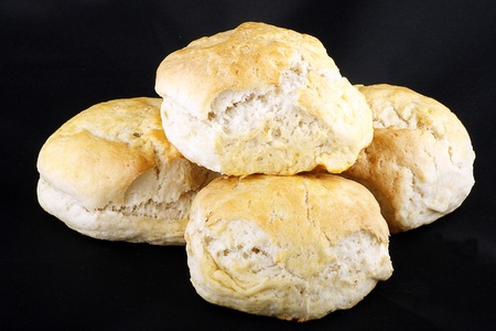 four fresh baked scones isolated on a black backgroundの写真素材