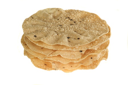 indian food stack of spiced poppadoms isolated on a white backgroundの写真素材