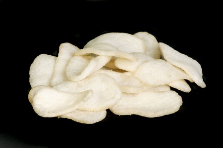 chinese prawn crackers isolated on a black backgroundの写真素材