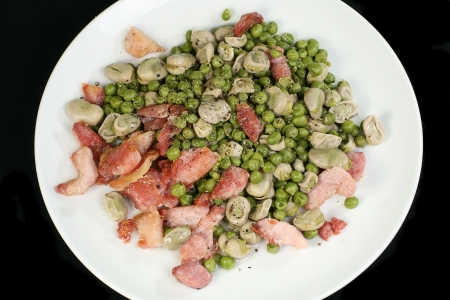 grilled bacon peices peas and beans  on black backgroundの写真素材