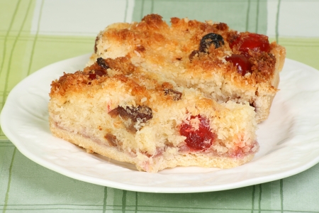 two slices of coconut topped cherry cakeの写真素材