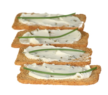 melba toast spread with cream cheese and chivesの写真素材
