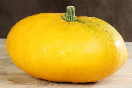 yellow vegetable squash on a wooden tableの写真素材