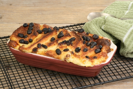 Home baked bread and butter pudding with mixed fruit on a cooling rackの写真素材