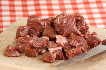 Raw diced beef steak and kidney on a chopping boardの写真素材