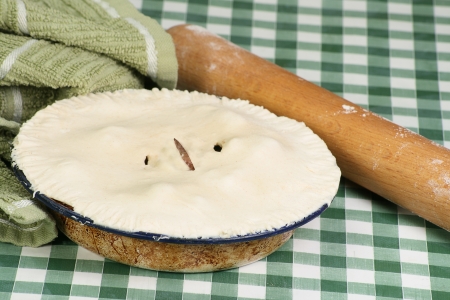 uncooked kidney pie with floured rolling pinの写真素材