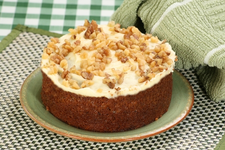 carrot cake wit buttercream icing and chopped walnutsの写真素材