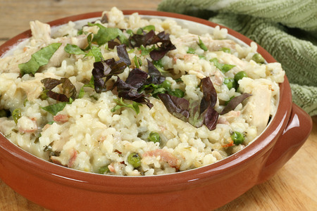   food chicken and bacon risotto in a terracotta bowl                             の写真素材