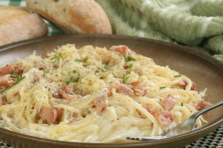    spaghetti carbonara with sauce and chopped bacon                            の写真素材