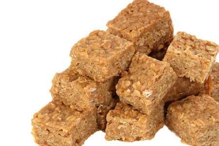 Pile of oat flapjacks isolated on a white background                               の写真素材