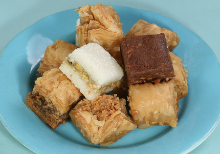         pile of assorted sweet baklava on a blue plate                       の写真素材