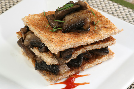   triple layer of fresh fried field mushrooms on toast slices                             の写真素材