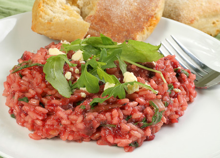 Beetroot risotto with crumbled goats cheese and rocket leavesの写真素材