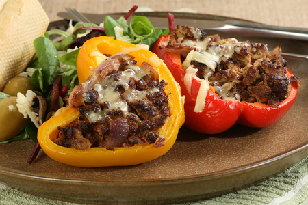 two roast stuffed peppers with saladの写真素材