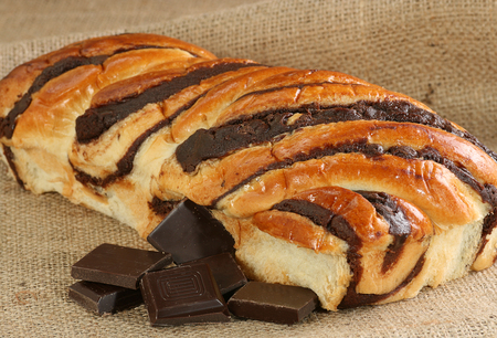 whole chocolate brioche loaf on a hessian backgroundの写真素材