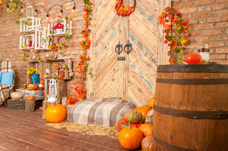 Autumn yellow leaves, pumpkins, autumn, straw, wooden door on the background.の写真素材