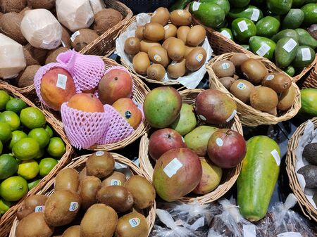 Avocados, coconuts, limes, kiwi and mangoes, fruit is beautiful in woodenの写真素材