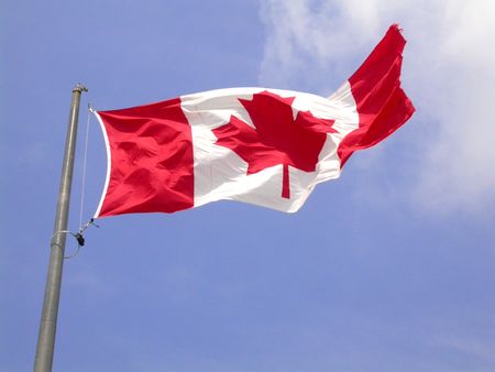 a canadian flag flapping in the wind from niagara fallsの写真素材