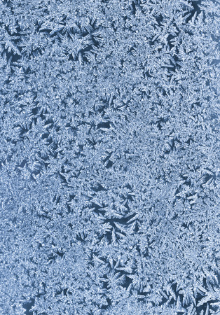 Frosty winter background photo of ice buildup on a windowの写真素材