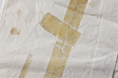 old yellowed sticky tape on a paper backgroundの写真素材