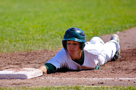 SHERBROOKE, CANADA - August 6: Shawn Bartley of New Brunswick slides back to first base in men's...