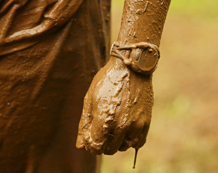 Closeup of mud-soaked watch, hand and arm at the Mud Run for Heart July 25, 2015, Waterford, New Brunswick, Canada.のeditorial素材