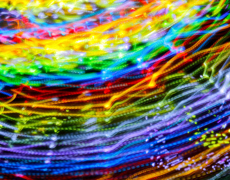 Handheld long exposure of a spinning fair ride at night.