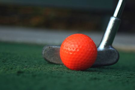 A mini-golf ball and putter.の写真素材