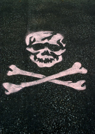 A skull stenciled on asphalt.の写真素材