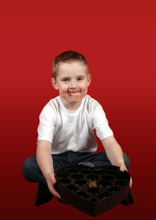 A little boy offering the last piece of candy.の写真素材