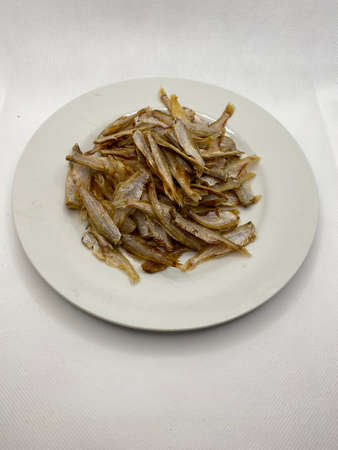 Small dry fish from the sun on the white background, pattern of dried fish and small dried fish.の写真素材