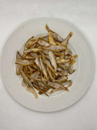 Small dry fish from the sun on the white background, pattern of dried fish and small dried fish.の写真素材