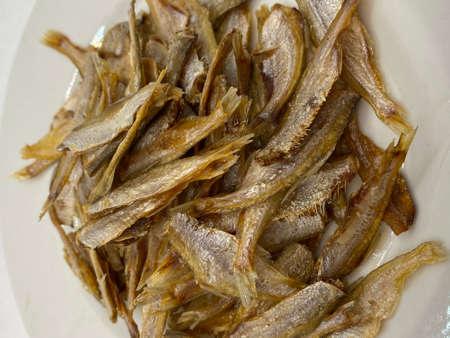 Small dry fish from the sun on the white background, pattern of dried fish and small dried fish.の写真素材