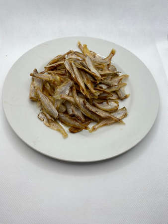 Small dry fish from the sun on the white background, pattern of dried fish and small dried fish.の写真素材