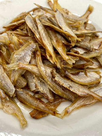 Small dry fish from the sun on the white background, pattern of dried fish and small dried fish.の写真素材