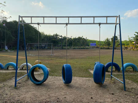 Colorful playground on yard at primary school in Thailand, outdoor sports playground for kids. Colorful playground made forn recycling rubber tire.の写真素材