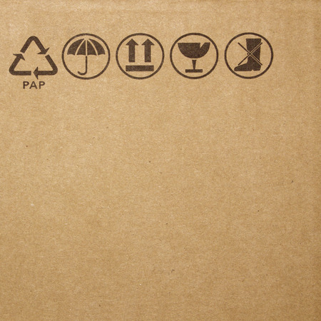 Fine image close-up of grunge black fragile symbol on cardboardの写真素材
