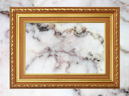 Gold frame Vintage photo frame on marble stone wall backgroundの写真素材