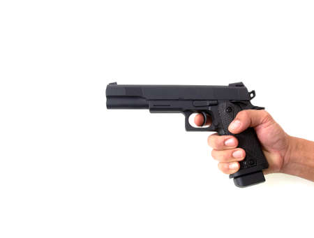 Handgun in male hand isolated on black backgroundの写真素材