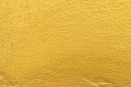 Golden background or texture of plaster wallの写真素材