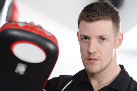 Male personal trainer with work-out padsの写真素材