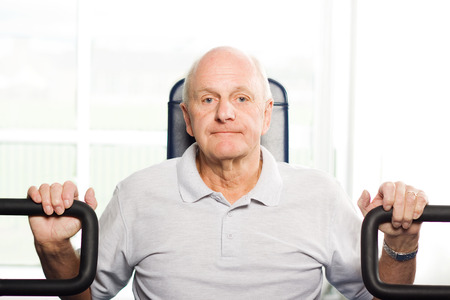 Mature older man working out in the gymの写真素材