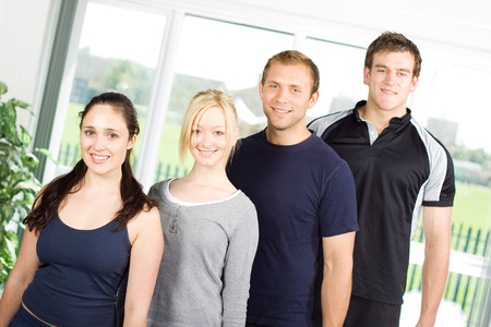 Group of sporty looking young fitness models in the gymの写真素材